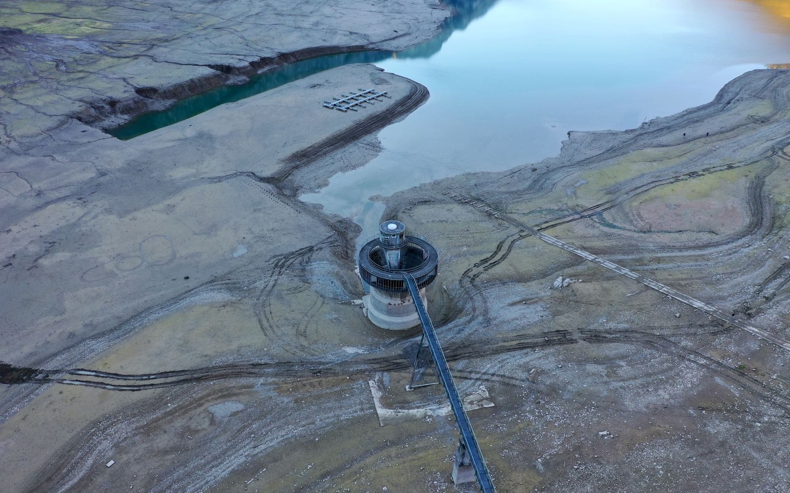 Lake Travis shoreline showing a pale caliche drought ring several feet above the current water surface, late afternoon